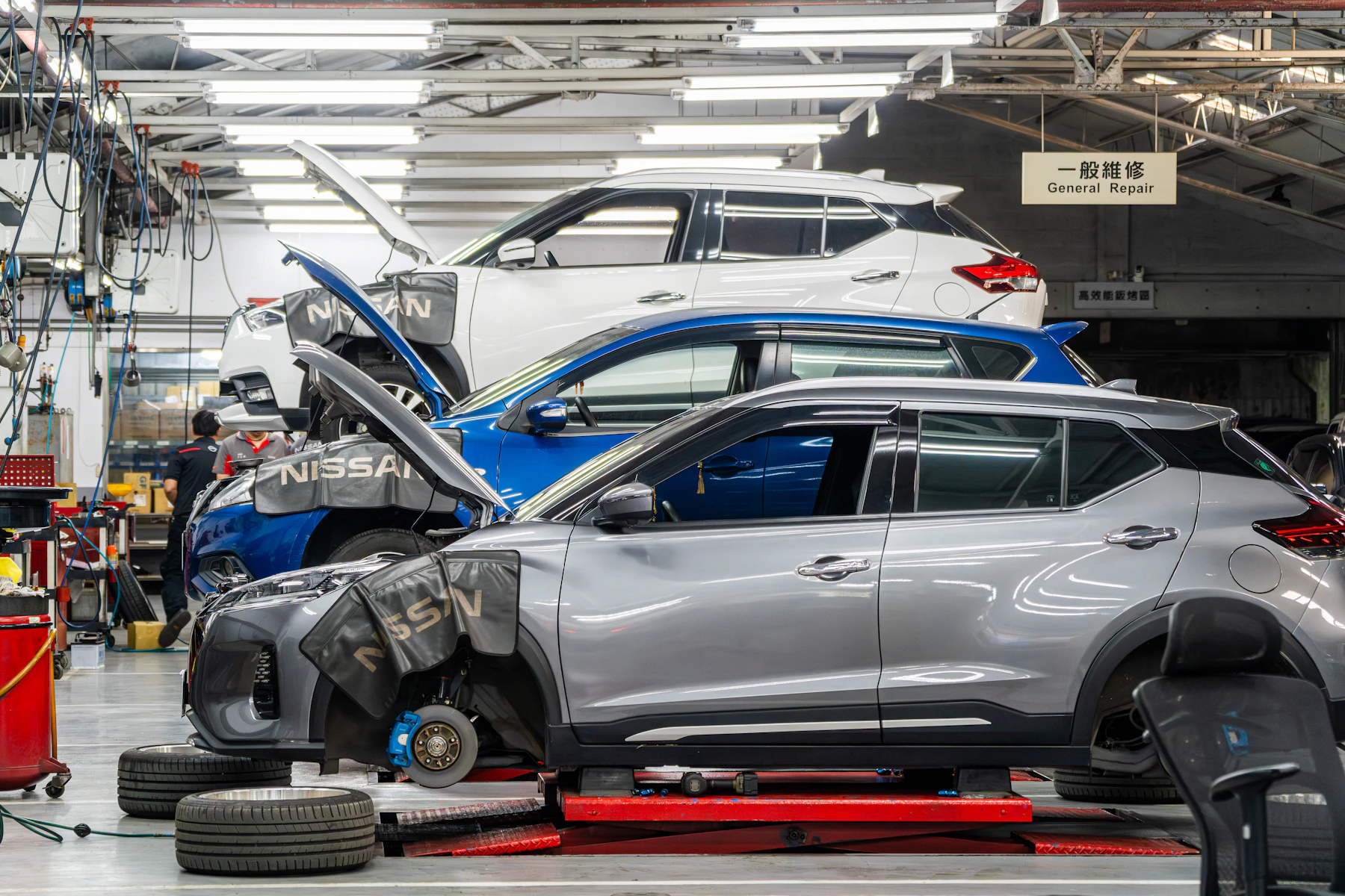 Vehicles being serviced in a professional repair bay